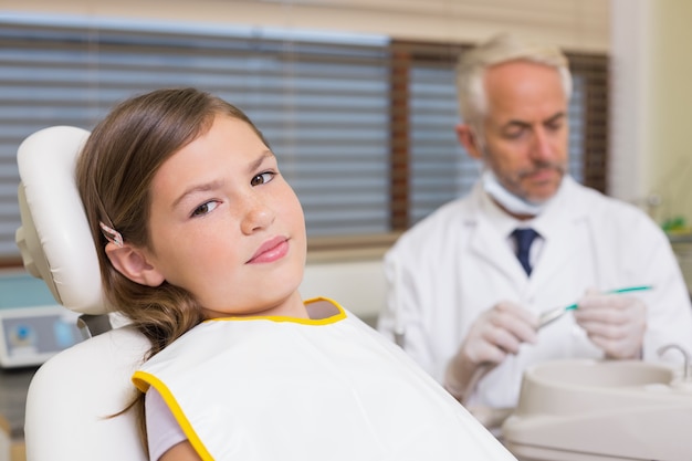 Little girl sitting in dentists chair