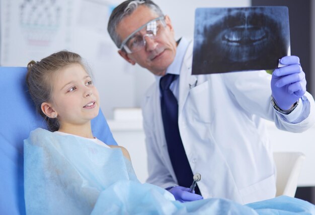 Little girl sitting in the dentists office