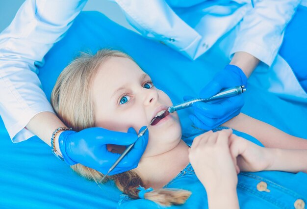 Little girl sitting in the dentists office