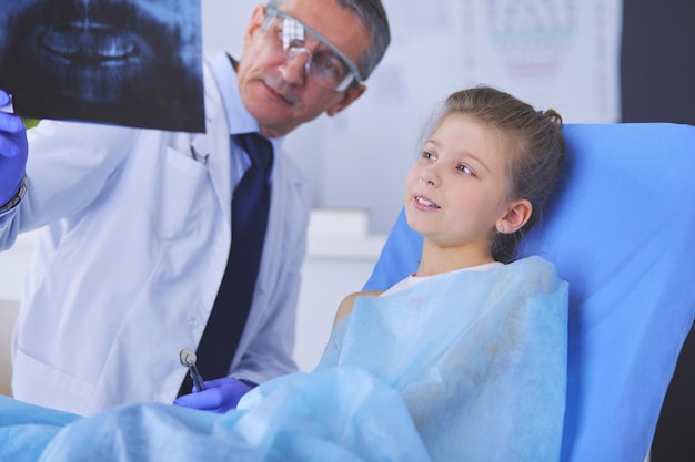 Little girl sitting in the dentists office