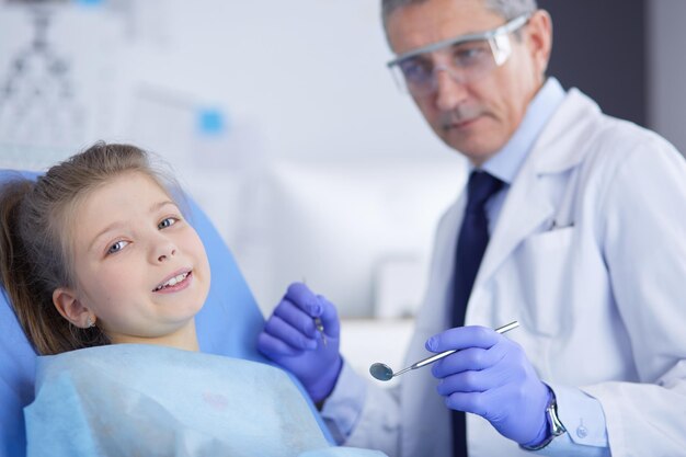 Little girl sitting in the dentists office