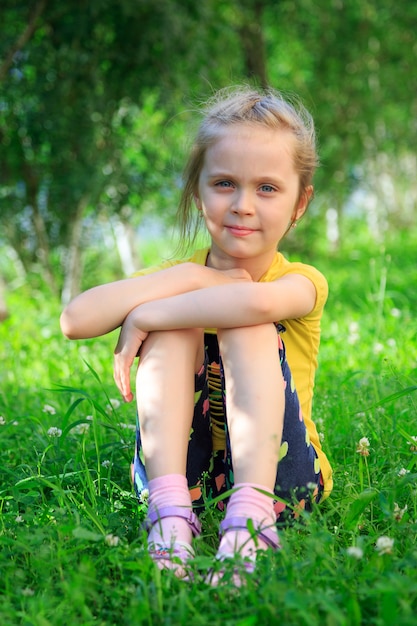 Little girl sitting in the grass