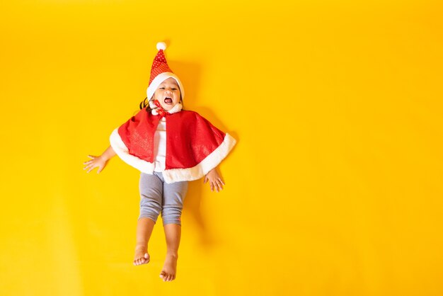 Little girl smile with dressed in red santa the concept of holiday christmas day