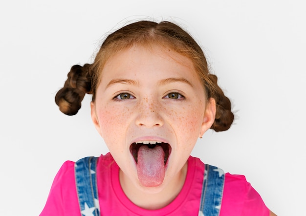 Photo little girl smiling happiness sticking out tongue studio portrait