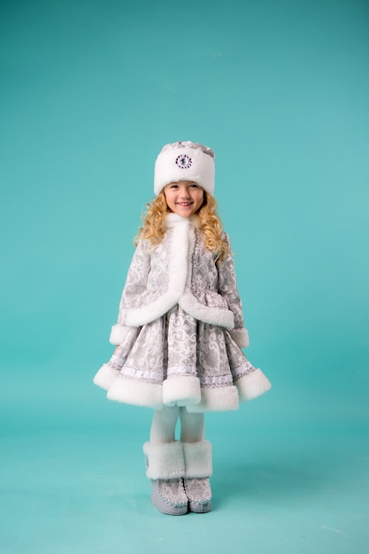 little girl smiling in snow maiden costume