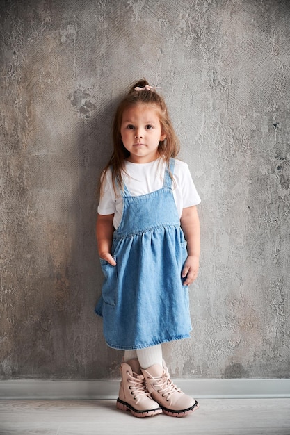 little girl standing by the wall in new apartment
