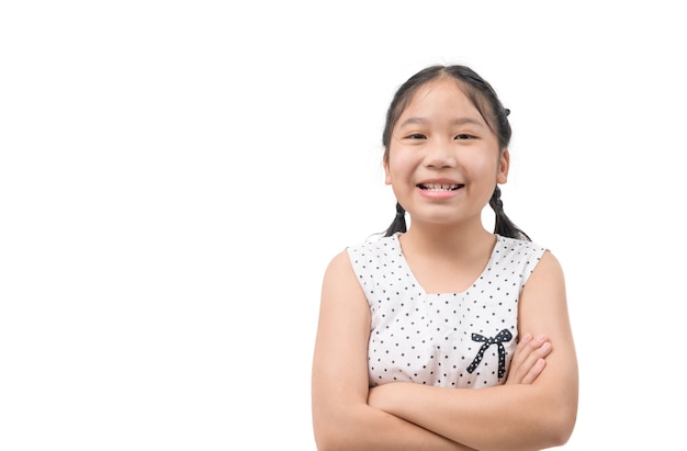 Little girl standing with arms folded and smiling isolated on white background.