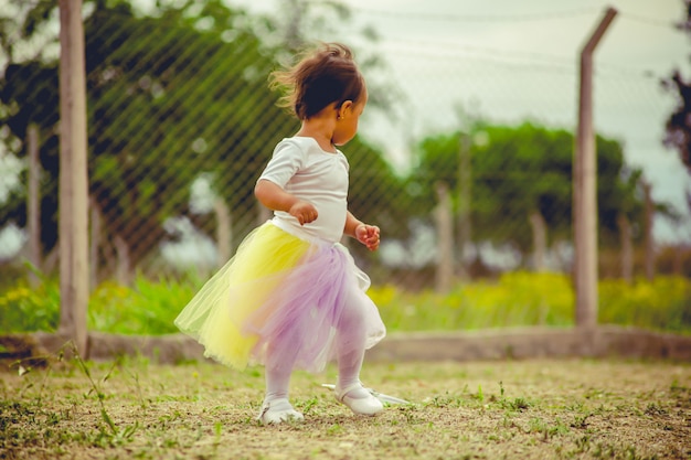 Photo little girl standing in the yard