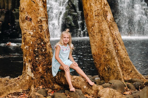 A little girl stands near the Rochester Waterfall on the Island of MauritiusA waterfall in the jungle of the tropical island of Mauritius