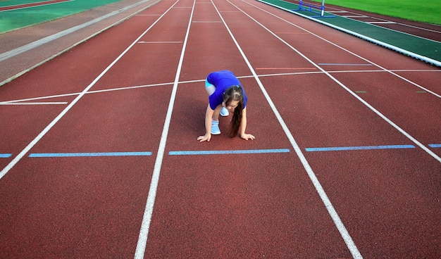 Little girl on the start on the stadium