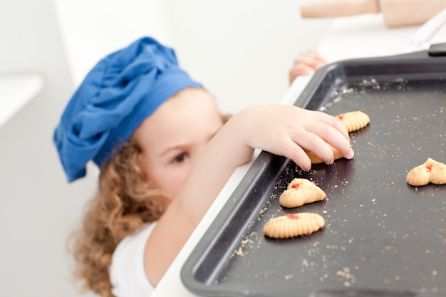 Little girl stealing cookies 