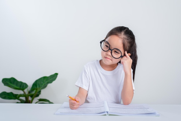 little girl study doing test in primary school Children writing notes in classroom  concept