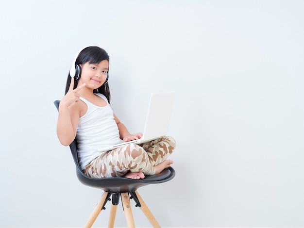 Little girl study online with laptop.