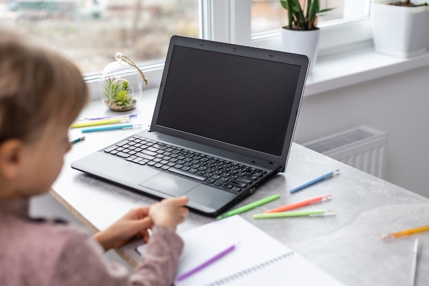 little girl studying with computer