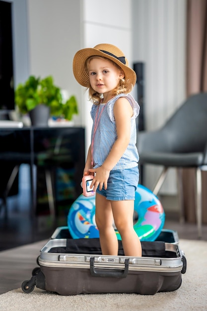 Little girl in suitcase baggage luggage ready to go for traveling on vacation