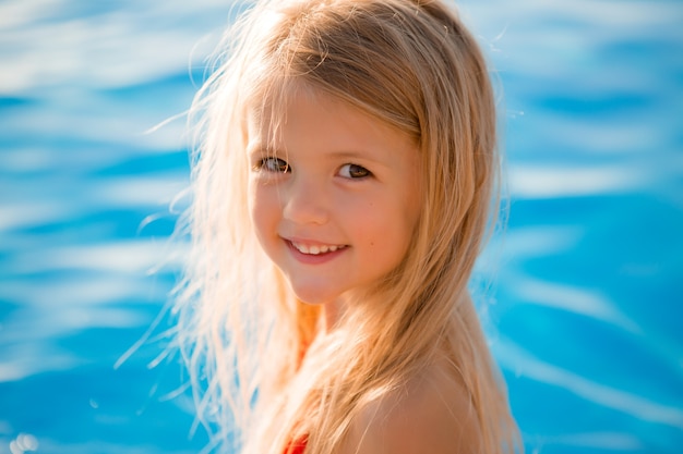 Little girl in summer at the pool