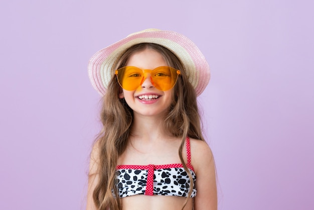 Premium Photo | A little girl in a swimsuit is happy and smiling.