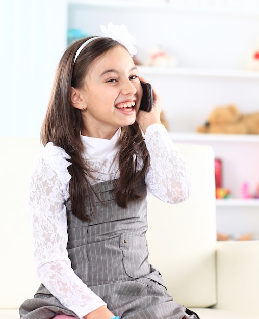 Little girl talking on the phone.