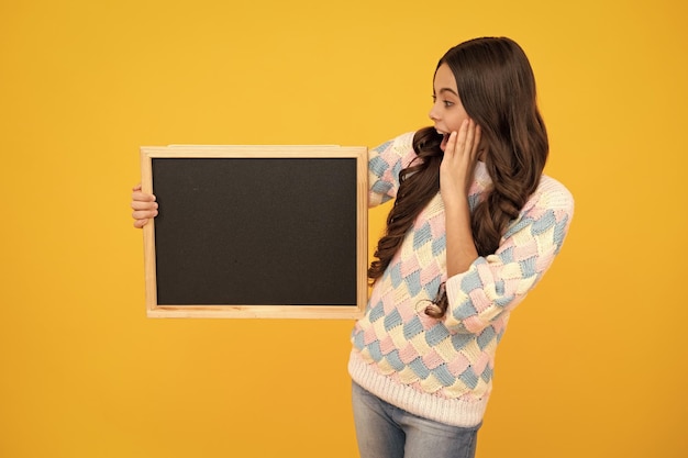 Little girl teen with blackboards Teenager school girl hold blackboard for copy space school sale