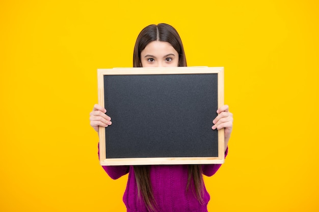 Little girl teen with blackboards teenager school girl hold blackboard for copy space school sale