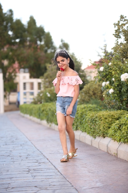 Little girl teenager walking on field with flowers lifestyle on nature