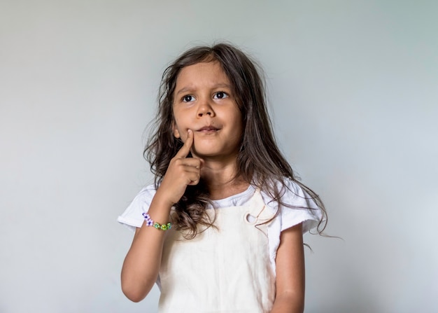 Little girl thinking at home