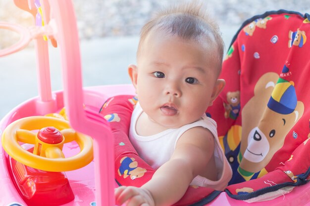 Little girl in a toy car cabin