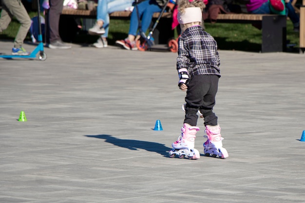 Little girl training to run by rollers Youth activity and healthy lifestyle Sports training