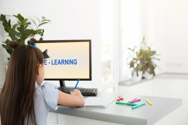 Photo little girl using computer concept, distance online learning