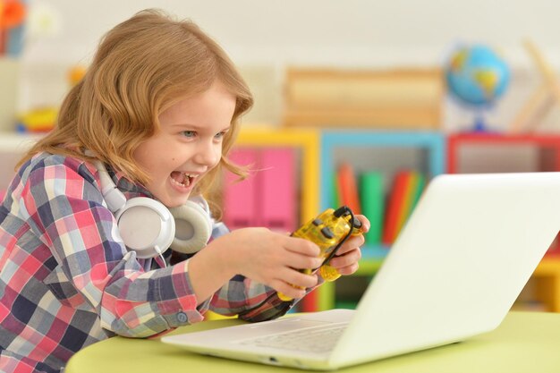 Little girl using modern laptop