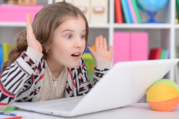 Little girl using modern laptop