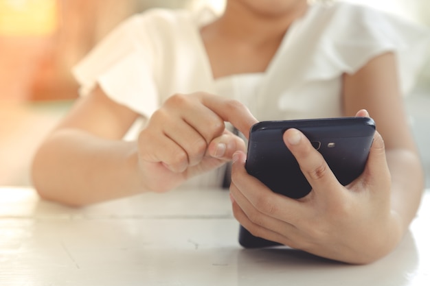 Little girl using smartphone, Social media concept.