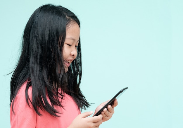 Little girl using smartphone in studio