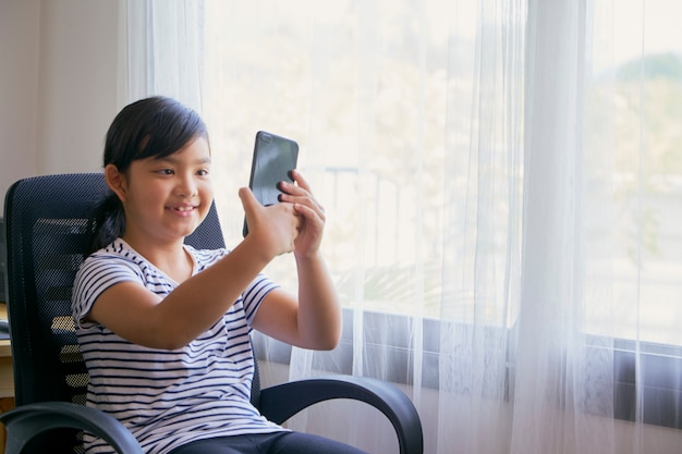 Little girl using smartphone for video call