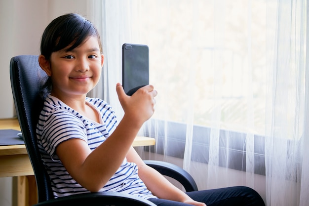 Little girl using smartphone for video call