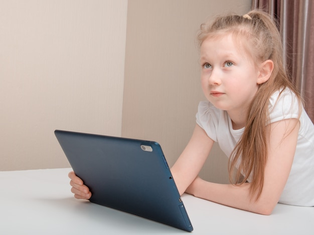 Little girl using tablet at home