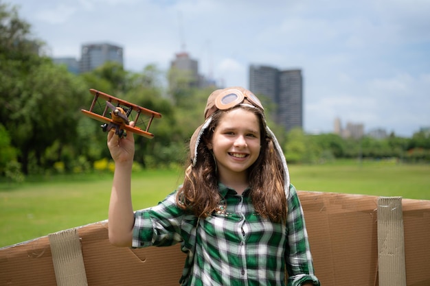 A little girl on vacation at the park with a pilot outfit and flying equipment Run around