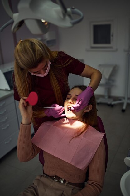 Little girl visiting dentist in clinic Conception of stomatology