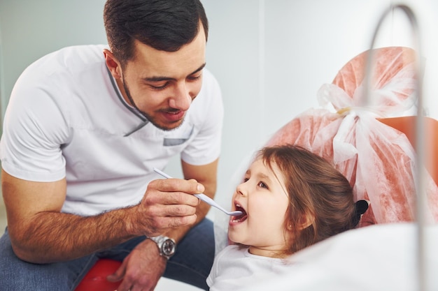 Little girl visiting dentist in clinic Conception of stomatology