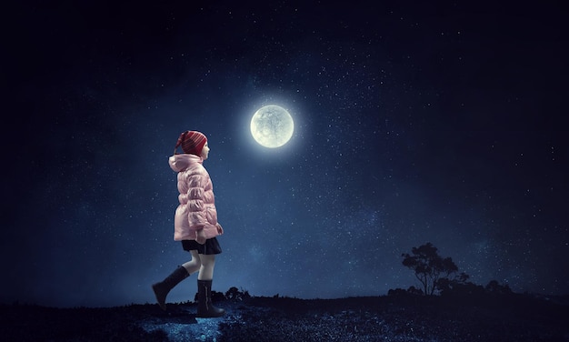 A little girl walks alone on a beautiful full moon night. Mixed media