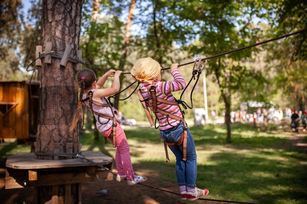 A little girl walks along the cableway in the park