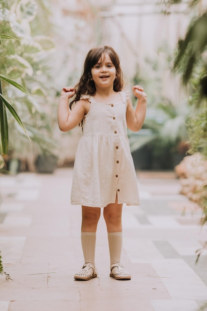 a little girl walks in the botanical garden happy baby and palm trees