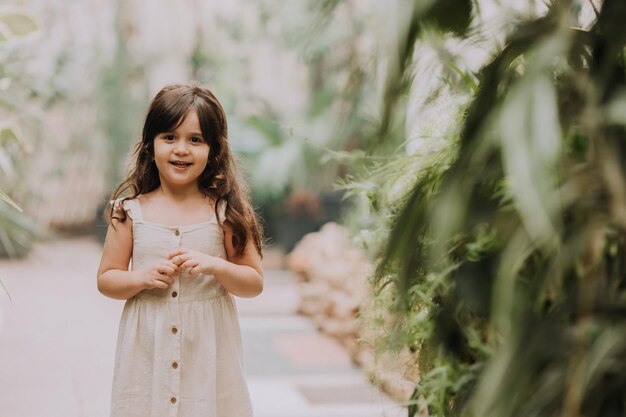 a little girl walks in the botanical garden happy baby and palm trees