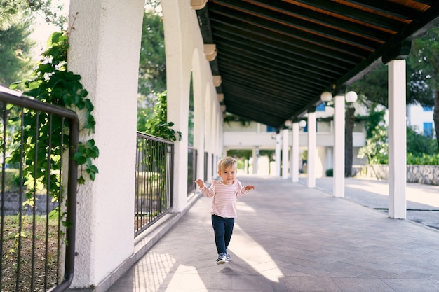 Little girl walks through the long pavilion