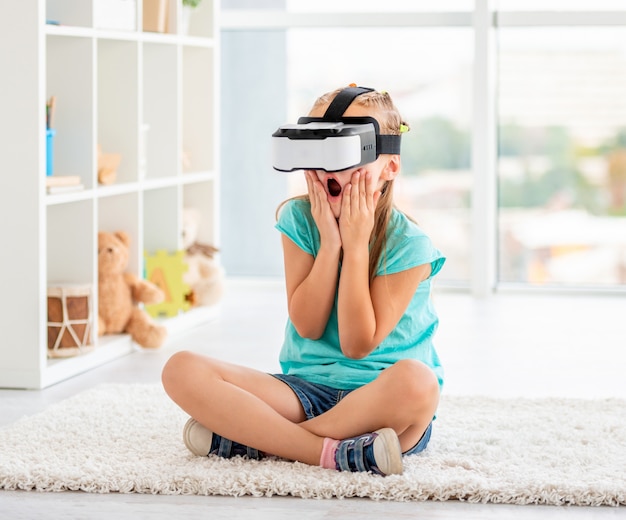 Little girl watching movies via VR