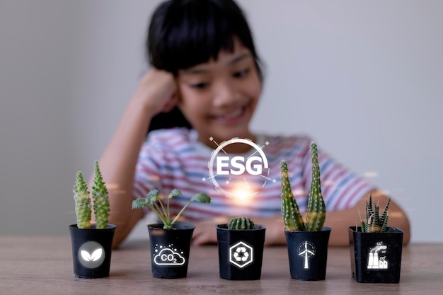 Little girl watching a plant Environmental technology concept Sustainable development goals ESG