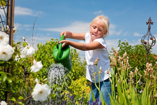 Little girl watering the flowers