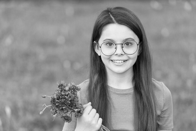 Little girl wear vintage rim eyeglasses green lawn background beautiful child concept