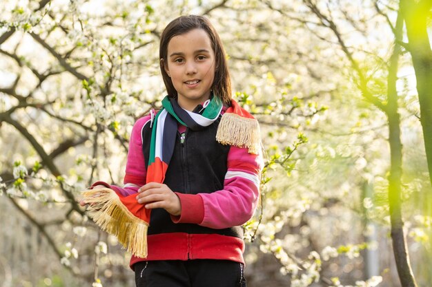 A little girl wearing an emirates flag ribbon