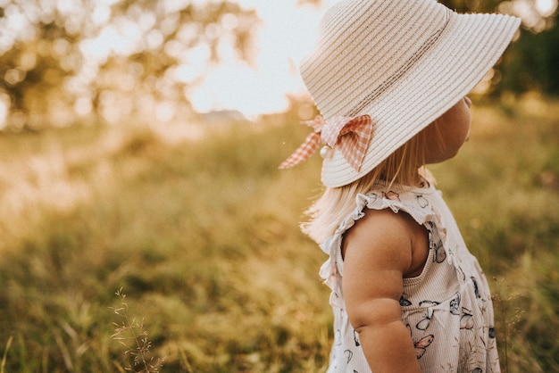 Little girl wearing a hat walking